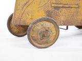 a yellow toy car with wheels on a white surface