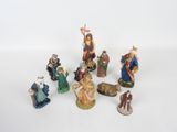 many figurines of different sizes and colors on a white surface