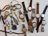 many different types of watches on display on the wall