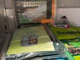 a refrigerator filled with books and magazines on top of it