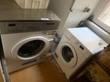 a washer and a dryer in a small room
