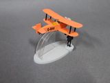 a small model of a plane with a man standing next to it