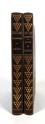 the two books are sitting side by side on a white surface