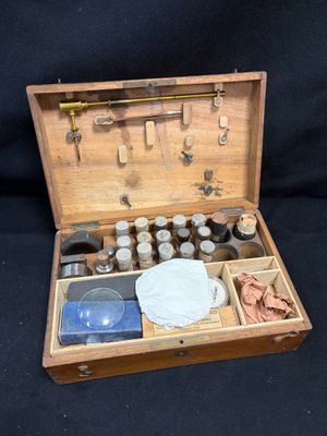 a wooden box with a variety of items inside of it