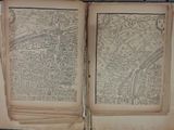 an old book with a map of a city inside of it