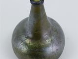 a green vase that is sitting on a white surface