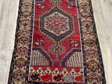 a red rug on a wooden floor in a room