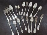 a lot of silver spoons and forks on the table
