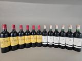 several bottles of wine are lined up in a row on a table