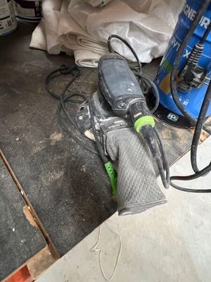 a sander and a sander on the floor in a garage