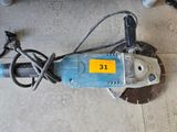 a small electric drill on the floor with a cord