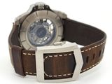 a watch that is sitting on a brown leather strap