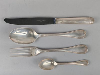 five spoons, a knife, and a fork on a table