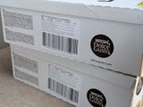 two boxes of doughnuts are stacked on top of each other