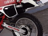 a red and white yamaha motorcycle parked in a garage