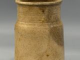 a brown vase that is sitting on a table