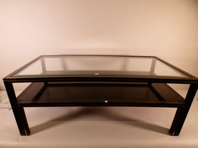 a glass coffee table with a glass top on a white surface
