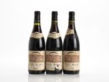 three bottles of wine sitting next to each other on a white surface