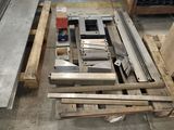 several pieces of steel sit on pallets in a warehouse