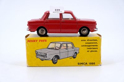 a red toy car sitting on top of a box