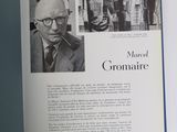 an open book with a picture of a man smoking a pipe