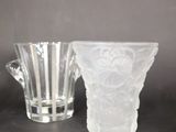 two glass vases sitting next to each other on a table