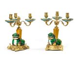 pair of green and gold candelabs with a frog on a pedestal