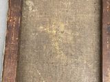an old wooden picture frame with a brown cloth on it