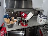 a kitchen with a stove, oven, sink, and other appliances