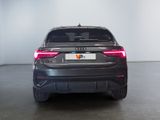 the rear end of a grey audi suv parked in a garage