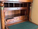 a wooden desk with a green mat on top of it