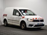 the white van is parked in a room with a checkered floor