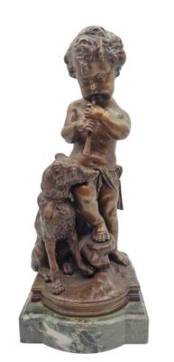 bronze statue of a boy with a dog on a marble base