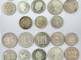 a group of twenty different british coins on a white surface