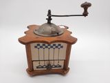 a coffee grinder sitting on top of a wooden table