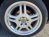 a close up of a car ' s tire on the road
