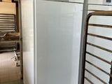two white refrigerators in a kitchen next to each other