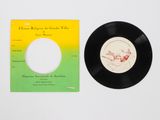 a black record sitting next to a yellow and green record