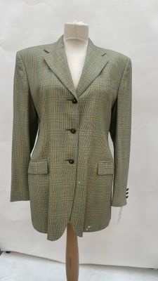 a mannequin wearing a green and black jacket on a mannequin stand