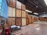 many wooden boxes stacked on top of each other in a warehouse