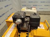 a small engine sitting on top of a yellow cart