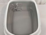 a white toilet that is sitting on a white sheet