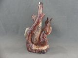 a small statue of a squirrel on a tree stump