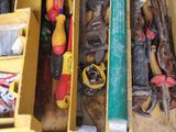 a box full of tools that are sitting on the floor
