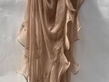the skirt is hanging on a hanger on a white wall