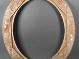 an old wooden frame with holes in it on a gray background