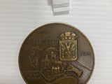 un gros plan d'une médaille posée sur une surface blanche, avec une étiquette de prix