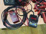 a table with a bunch of wires and electronic equipment on it