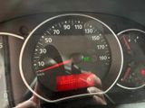 dashboard view of a car with a speedometer and a red light