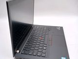the laptop is open on a white surface with a red button on the keyboard